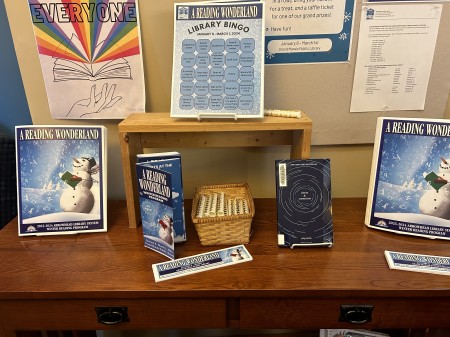 Table with Library Bingo cards and other winter reading program materials